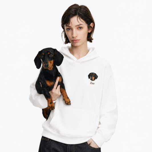 Customized pet portrait hoodie in white with embroidered dachshund dog face and name Leo.
