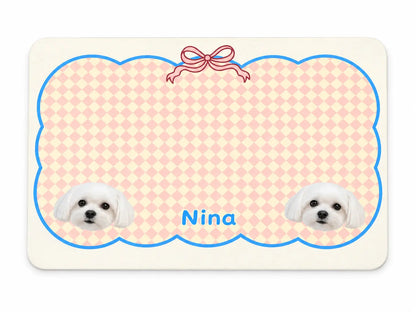 Custom waterproof non-slip pet feeding mat featuring pink argyle pattern, cute ribbon bow, and personalized pet photos