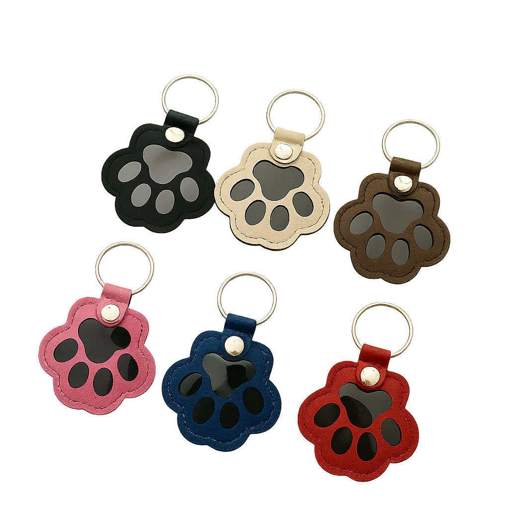 Custom paw-shaped leather pet fur keepsake keychain in black, beige, and brown, featuring a transparent window for fur storage and a personalized portrait on the back.