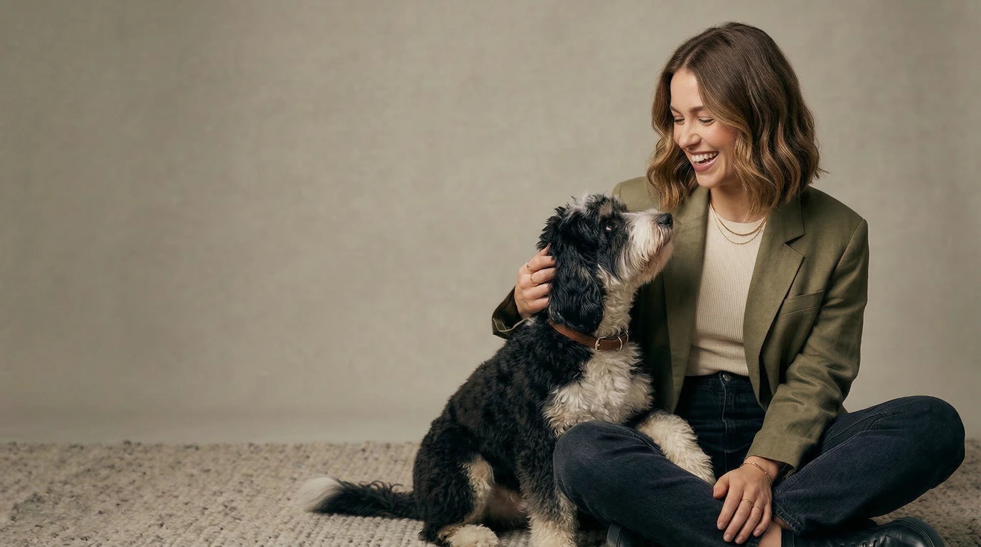 Petailor - Personalized Pet Gifts & Bespoke Creations. A happy owner with her dog, showcasing our custom lifestyle products and tailored pet gear.